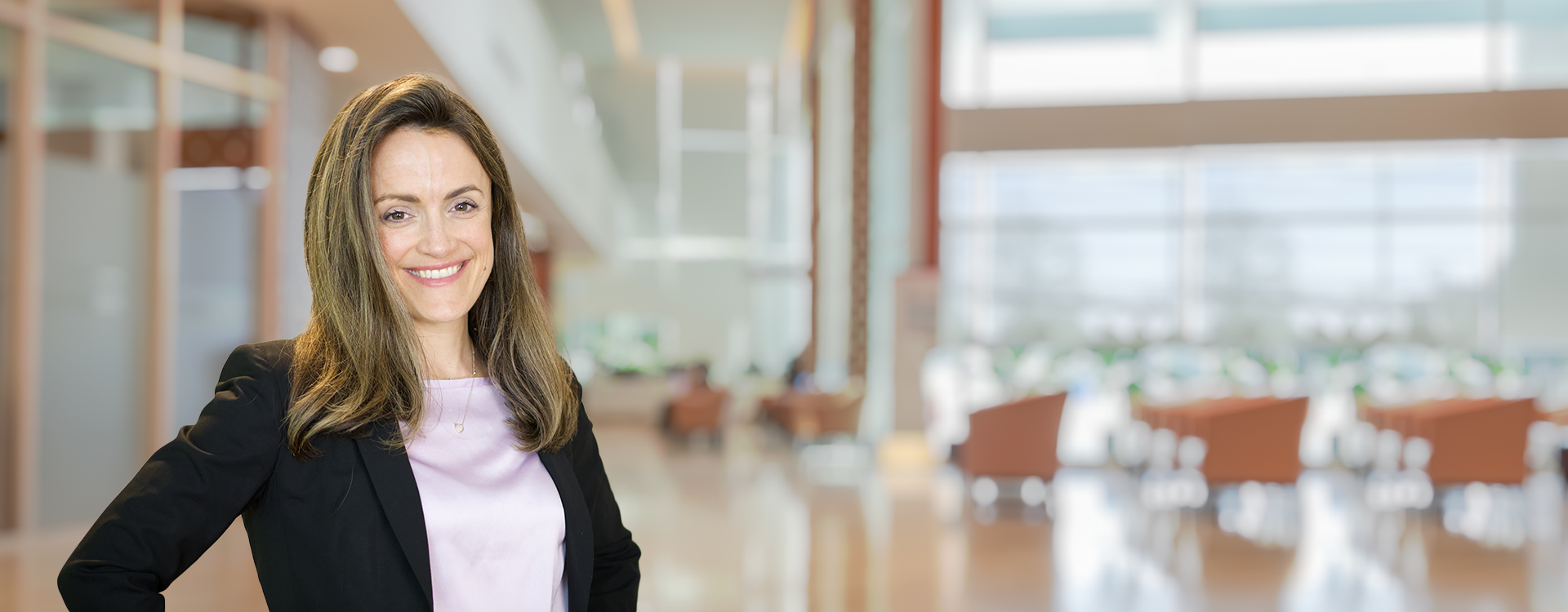 Anne-Marie standing in a business area, smiling